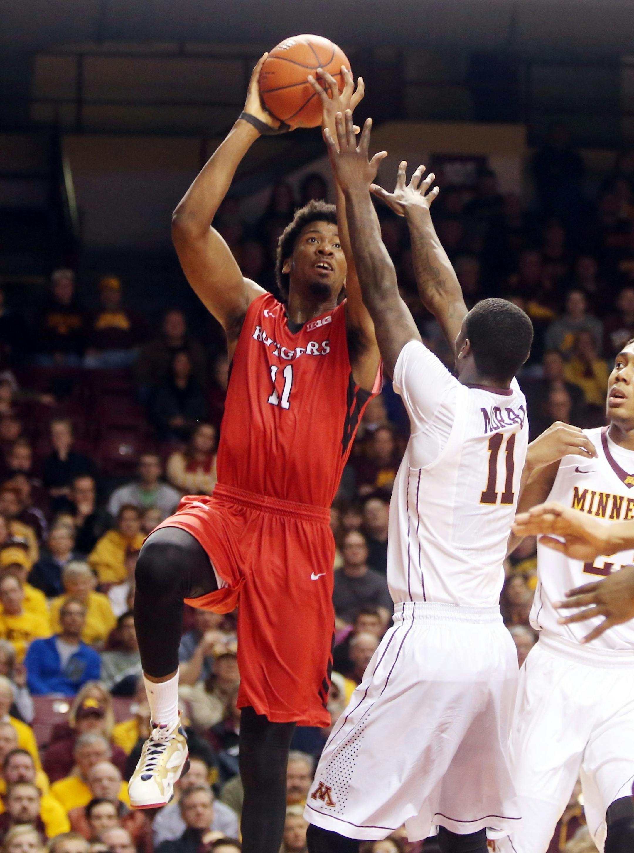 Rutgers&#x2019;s Kadeem Jack, left, shoots as Minnesota&#x2019;s Carlos Morris defends in the first half of an NCAA college basketball game, Saturday, Jan. 17, 2015, in Minneapolis. (AP Photo/Jim Mone)
