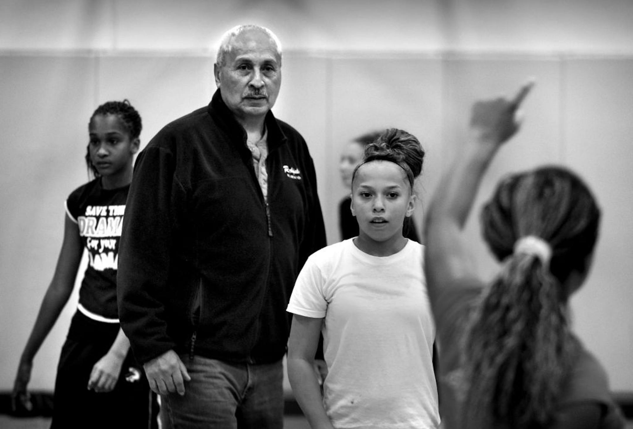 Respect Sports founder Frank White looked on while a 12-and-under girls' basketball team practiced at the Oxford Community Center in St. Paul.