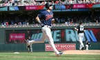 Minnesota Twins' Max Kepler, left, jogs home on his three-run home run off Chicago White Sox pitcher Josh Osich, right, in the seventh inning of a bas