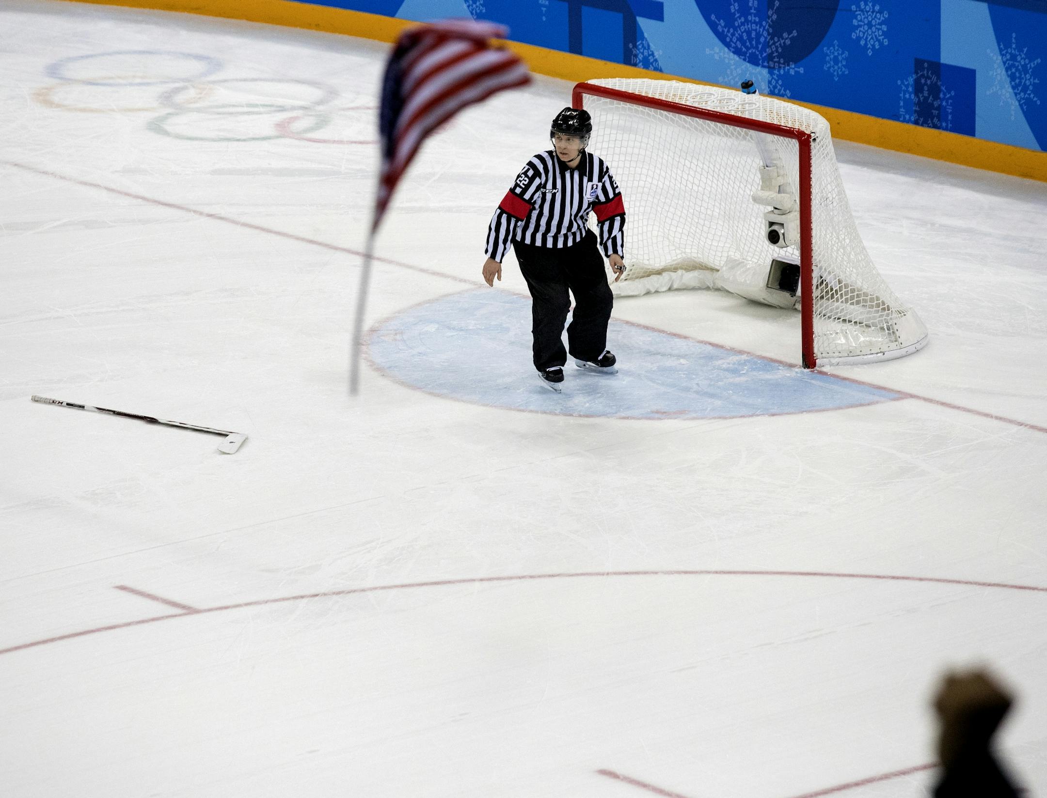 A fan threw up a flag after USA goalie Maddie Rooney (35) blocked a shot by Meghan Agosta on the last attempt of the shootout to win the game. USA beat Canada 3-2 in a shootout to win the gold medal at Gangneung Hockey Centre on Thursday.
