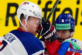 Czech Republic's Michal Kempny, right, punches the United States' Brady Tkachuk during the teams' quarterfinal match at the Ice Hockey World Champions