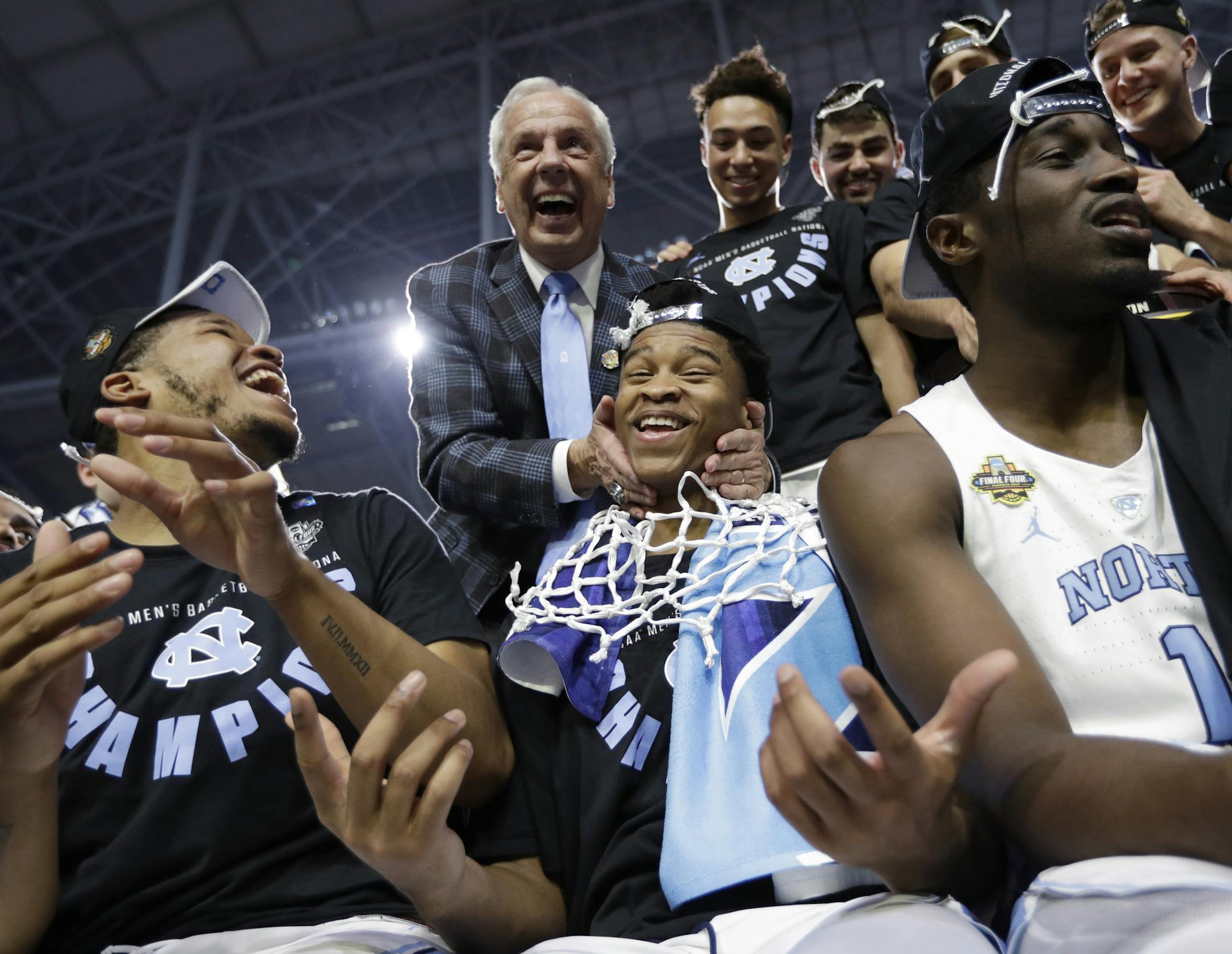North Carolina head coach Roy Williams celebrates with forward Isaiah Hicks, center, after the championship game against Gonzaga at the Final Four NCAA college basketball tournament, Monday, April 3, 2017, in Glendale, Ariz. North Carolina 71-65. (AP Photo/David J. Phillip)