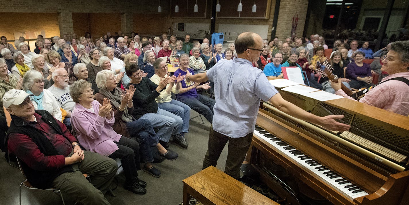 Dan Chouinard and Ann Reed worked with the crowd at Luther Seminary. He calls himself "an enabler of community singalongs."