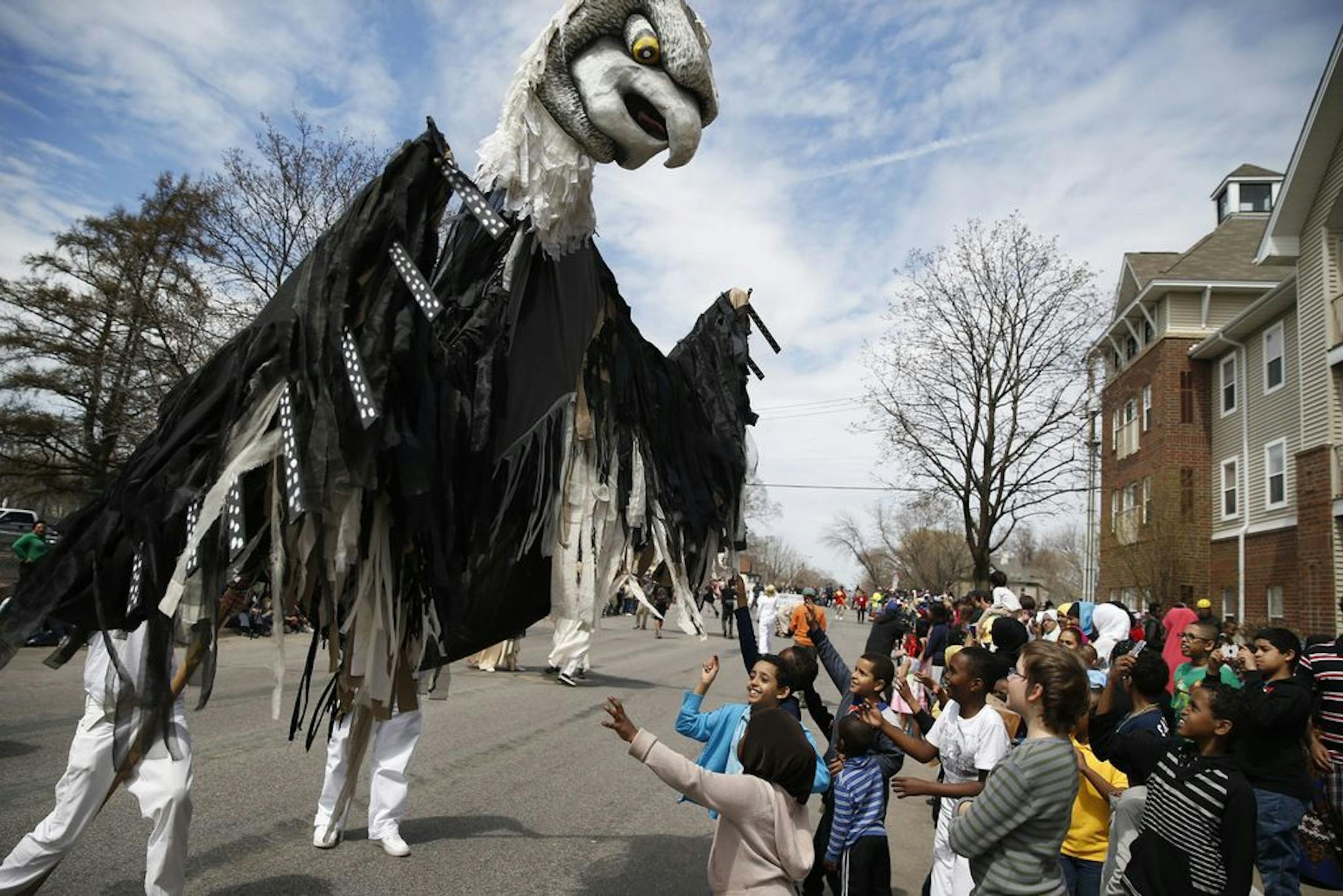 At a May Day parade in 2013 near Lake St. and Bloomington Ave. in Minneapolis, a raptor enthralled some of the younger spectators.