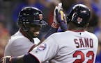 Minnesota Twins' Kennys Vargas, left, is congratulated by Miguel Sano (22) after his two-run home run off Kansas City Royals relief pitcher Kevin McCa