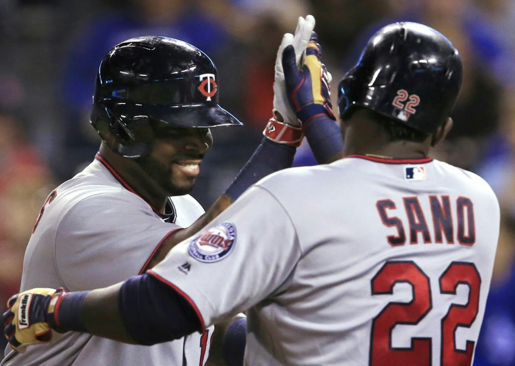 Minnesota Twins' Kennys Vargas, left, is congratulated by Miguel Sano (22) after his two-run home run off Kansas City Royals relief pitcher Kevin McCarthy during the sixth inning of a baseball game at Kauffman Stadium in Kansas City, Mo., Wednesday, Sept. 28, 2016.