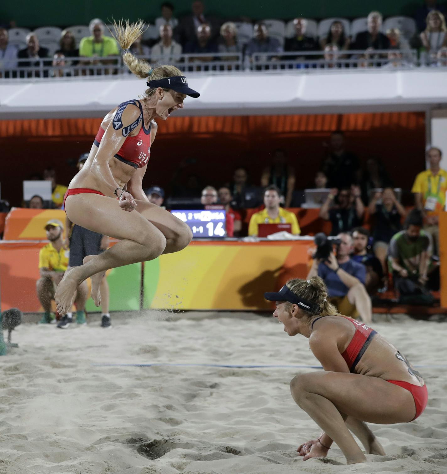 United States' Kerri Walsh Jennings, center, celebrates with teammate April Ross, right, after defeating Brazil during the women's beach volleyball bronze medal match of the 2016 Summer Olympics in Rio de Janeiro, Brazil, Wednesday, Aug. 17, 2016. (AP Photo/Marcio Jose Sanchez) ORG XMIT: OBVL123