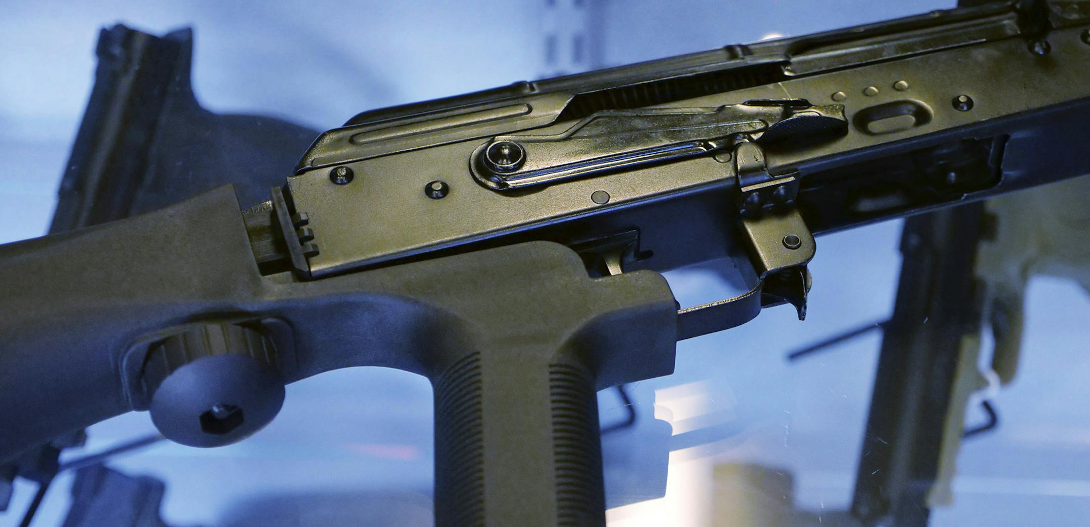 In this Oct. 4, 2017, photo, a device called a "bump stock" is attached to a semi-automatic rifle at the Gun Vault store and shooting range in South Jordan, Utah. The National Rifle Association announced its support Ton Oct. 5 for regulating the devices that can effectively convert semi-automatic rifles into fully automated weapons and that were apparently used in the Las Vegas massacre to lethal effect. It was a surprising shift for the leading gun industry group, which in recent years has reso