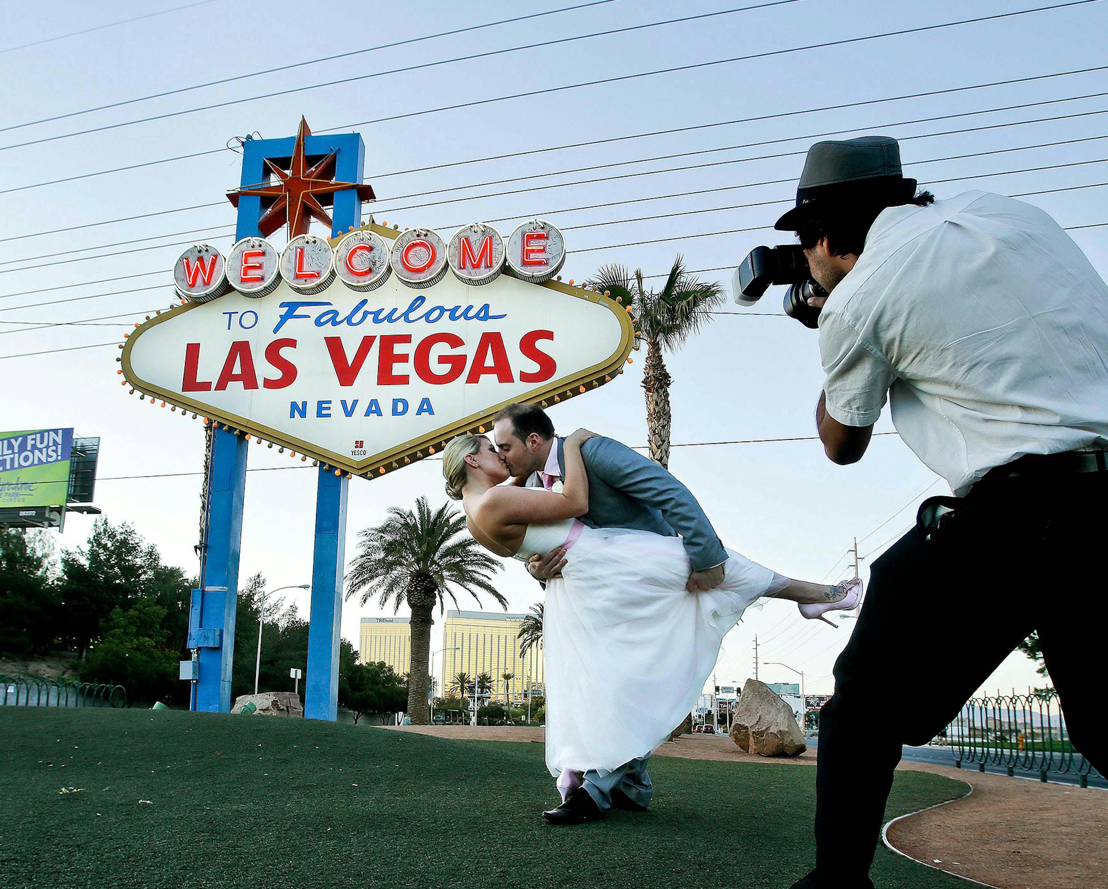 Katy Garrett and her husband, Stuart, strike a pose for photographer Bobby Jameidar on their wedding day in Las Vegas in April 2012. Las Vegas has seen a drop in weddings since 2004, and is planning a marketing campaign to lure couples back. (Mel Melcon/Los Angeles Times/TNS) ORG XMIT: 1171280