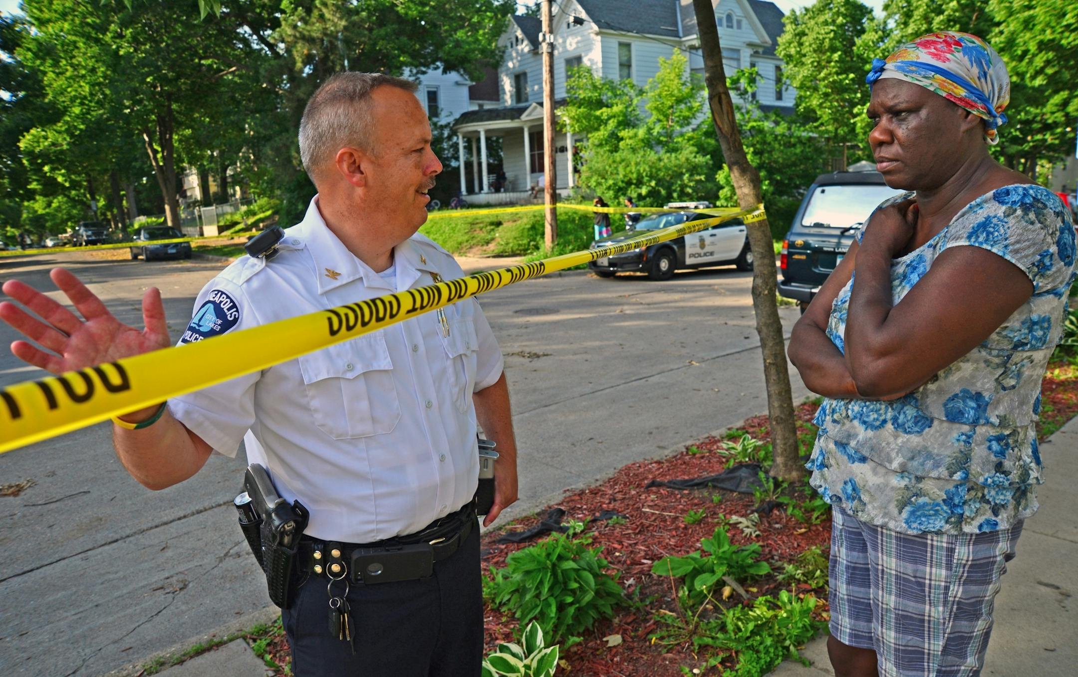 Fourth precinct Inspector Michael Kjos talked with Brenda Harris, who lives near the scene of the deadly shooting. He was reassuring her that there was no danger to the community.