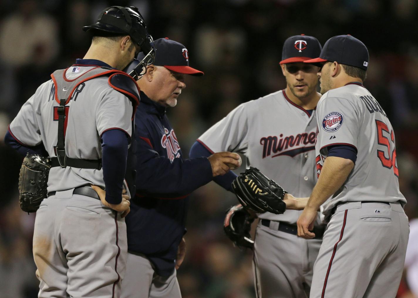 Minnesota Twins manager Ron Gardenhire gives the ball to relief pitcher Brian Duensing after pulling starter Vance Worley during the fifth inning of a baseball game against the Boston Red Sox at Fenway Park in Boston, Monday, May 6, 2013. (AP Photo/Charles Krupa) ORG XMIT: MIN2013050622043691