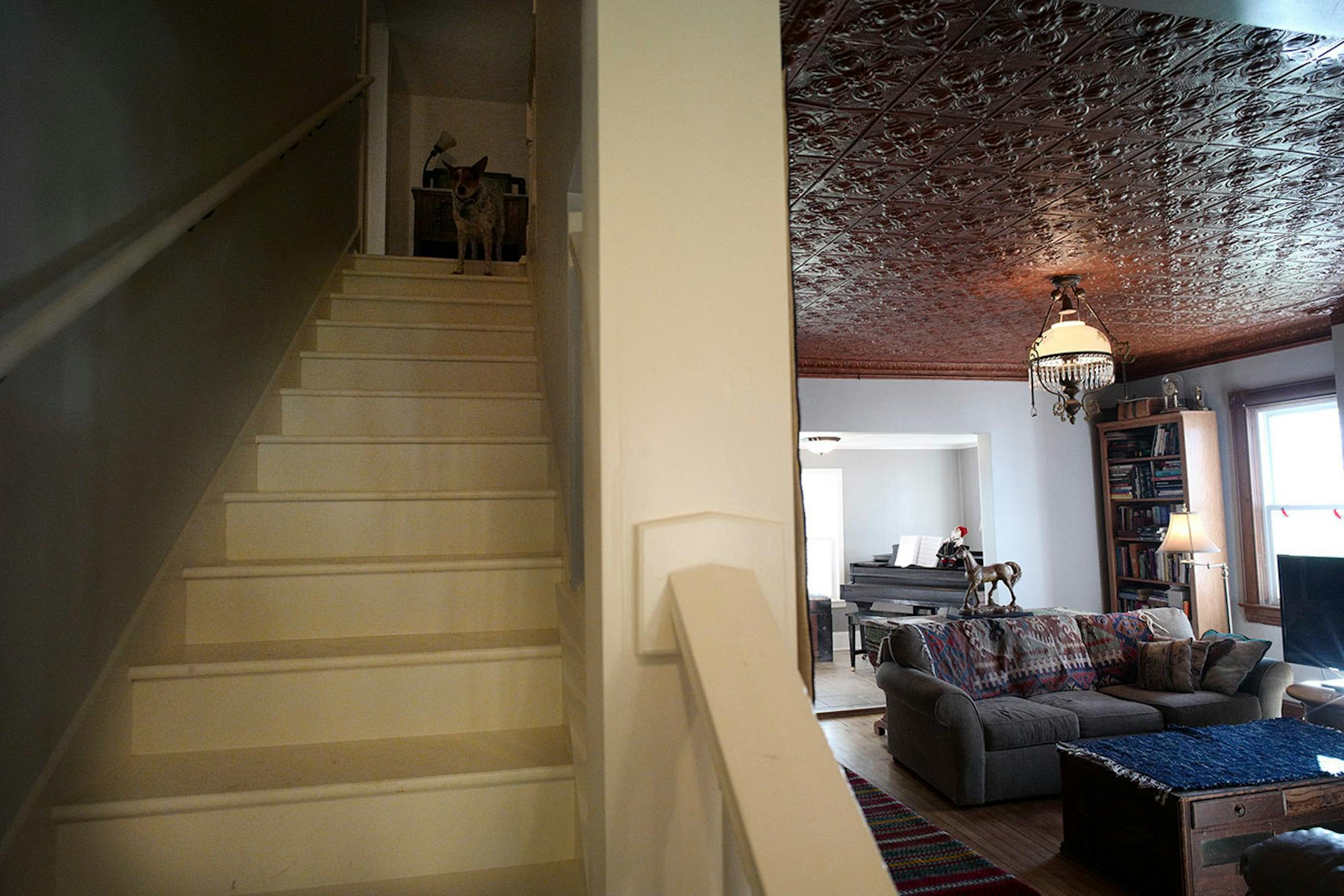 The rebuilt and rotated staircase opened up the main floor and created space for closets on the second floor. The living room still has the original tin ceiling, which was restored.