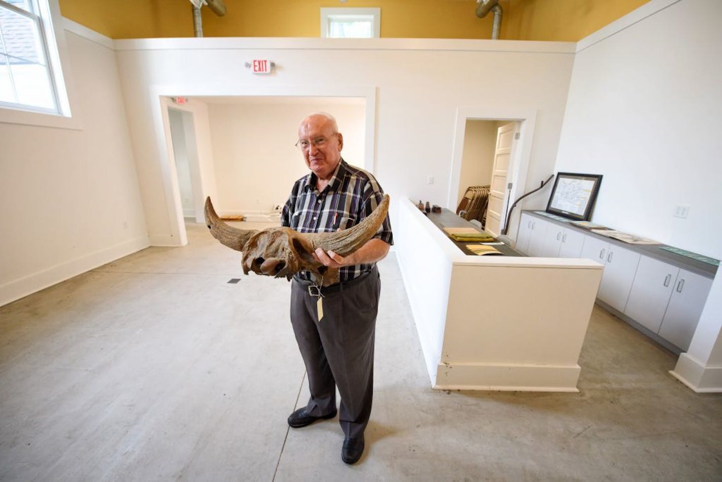 Golden Valley Historical Society member Don Anderson held a bison skull found during highway construction. It will be displayed in the new wing.