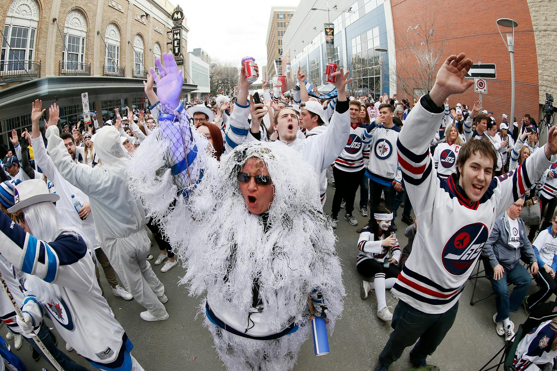 Winnipeg Jets fans attend a street party before Game 5 of an NHL hockey first-round playoff series between the Jets and the Minnesota Wild in Winnipeg, Manitoba, Friday, April 20, 2018.
