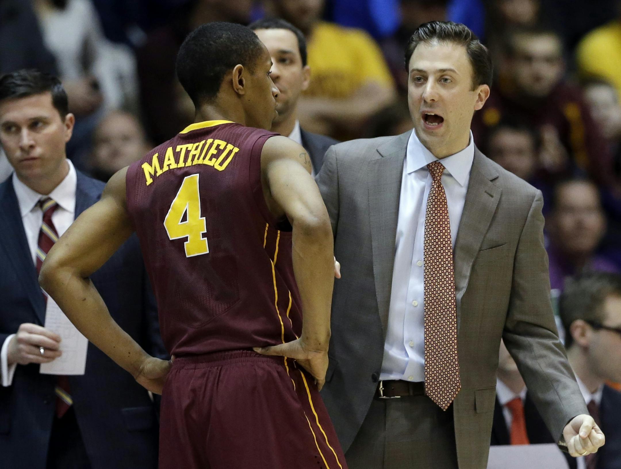 Minnesota head coach Richard Pitino, right, talks to guard DeAndre Mathieu (4) during the first half of an NCAA college basketball game against Northwestern in Evanston, Ill., Sunday, Feb. 16, 2014.