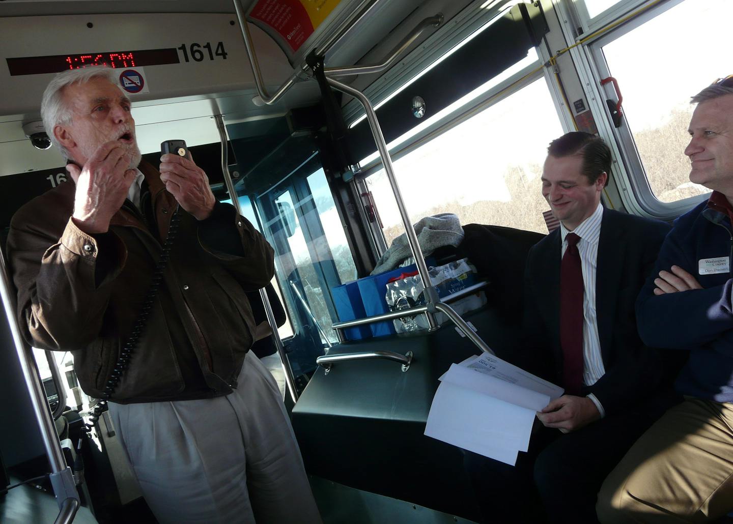 Alan Dale, president of Minnesota Tile and Stone, at left, outlines plans for a "nuclear blast" of development in Woodbury during a bus tour this month for Met Council Chair Adam Duininck, seated, to hear about plans for the Gold Line rapid busway. At far right is Don Theisen, Washington County public works director.