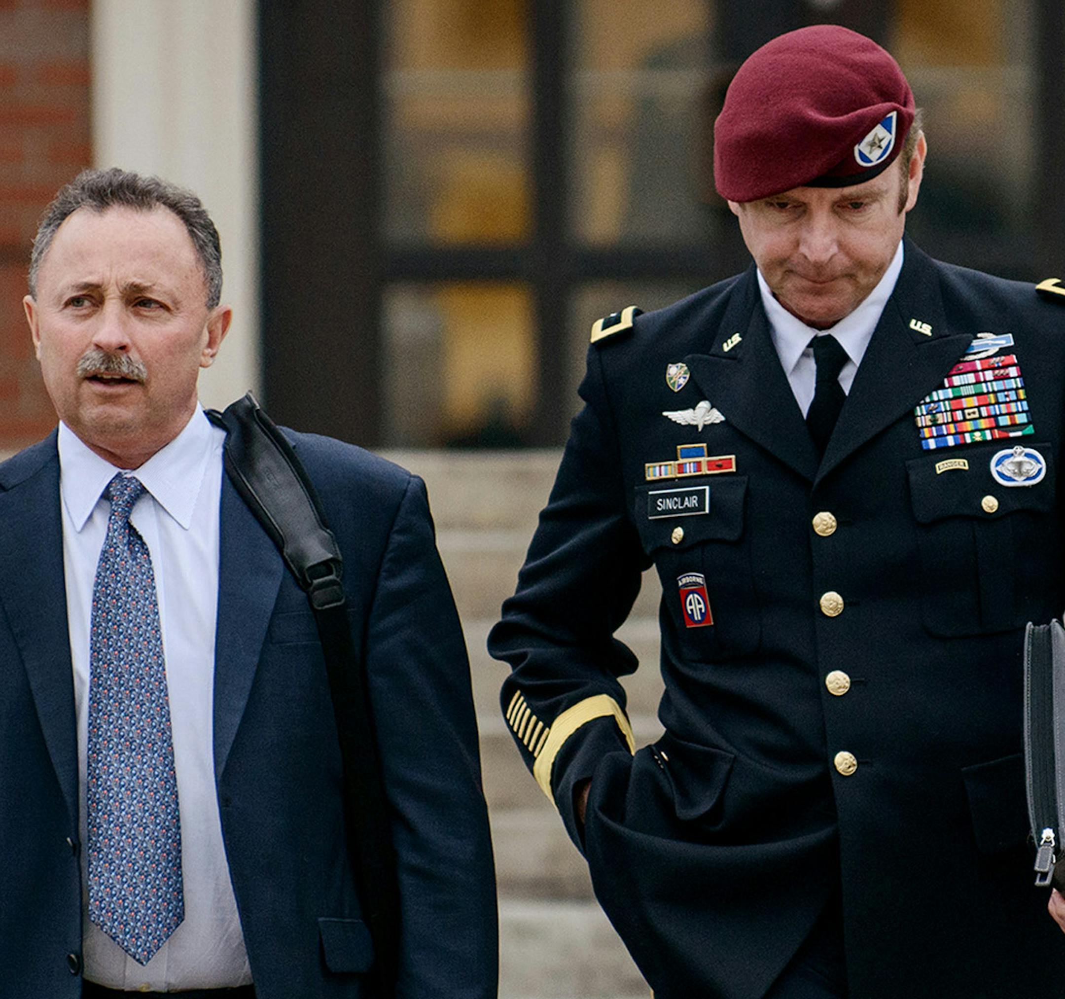 FILE - In this March 4, 2014, file photo, Brig. Gen. Jeffrey Sinclair, right, leaves the courthouse with his lawyers Richard Scheff, left, and Ellen C. Brotman, not pictured, following a day of motions at Fort Bragg, N.C. A military judge declined Monday, March 10, 2014, to dismiss sexual assault charges against Sinclair after reviewing what he said was evidence that political considerations influenced the military's handling of the case. (AP Photo/The Fayetteville Observer, James Robinson, File