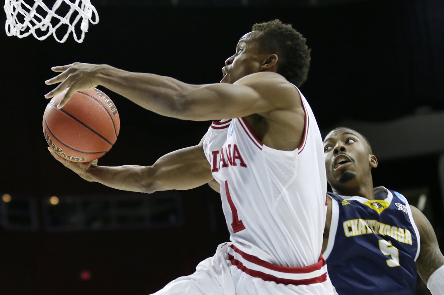 Indiana guard Yogi Ferrell drives to the basket past Chattanooga forward Justin Tuoyo, right, during the second half of a first-round men's college basketball game in the NCAA Tournament, Thursday, March 17, 2016, in Des Moines, Iowa. (AP Photo/Charlie Neibergall)