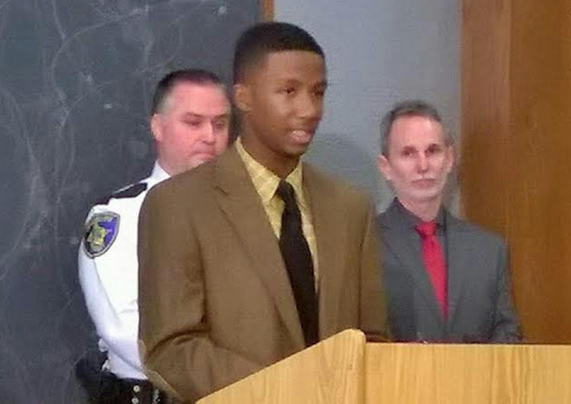 Trenton Washington spoke Friday at a news conference in Brooklyn Park. At left is Anoka County Sheriff James Stuart; at right, Youth Intervention Programs Association Executive Director Paul Meunier.