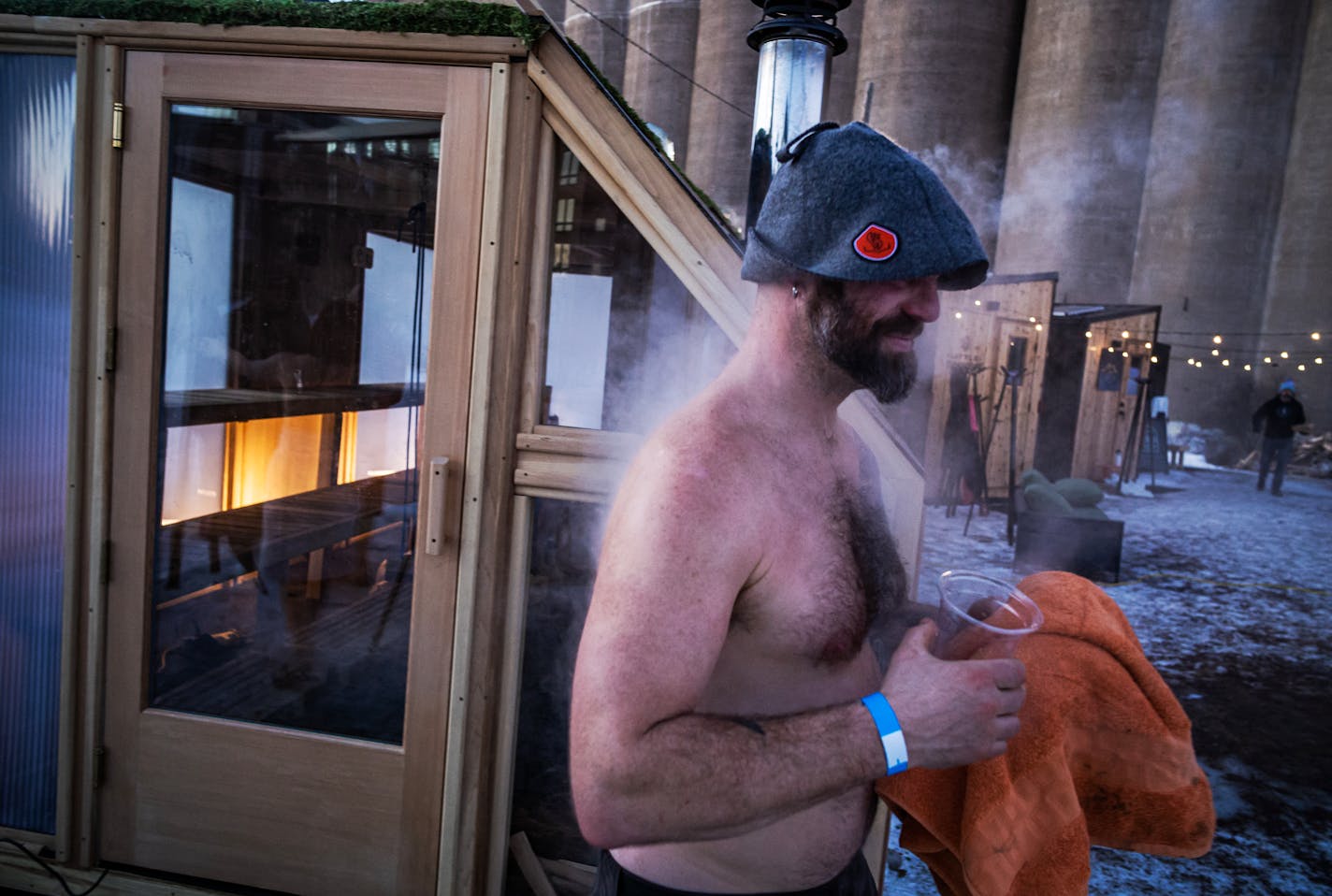 Sauna enthusiast Israel Lowell with his sauna hat emerges from the Superior Sauna &amp; Steam, one of the hotter saunas in Minneapolis, Minn., on Thursday, Feb. 2, 2023. The Great Northern Sauna Village is a social and therapeutic experience held this year at Malcolm Yards in Minneapolis. Visitors can immerse themselves in sauna culture by interacting with thermaculture first-hand during the festival's run in deep winter. ] RICHARD TSONG-TAATARII • richard.tsong-taatarii @startribune.com