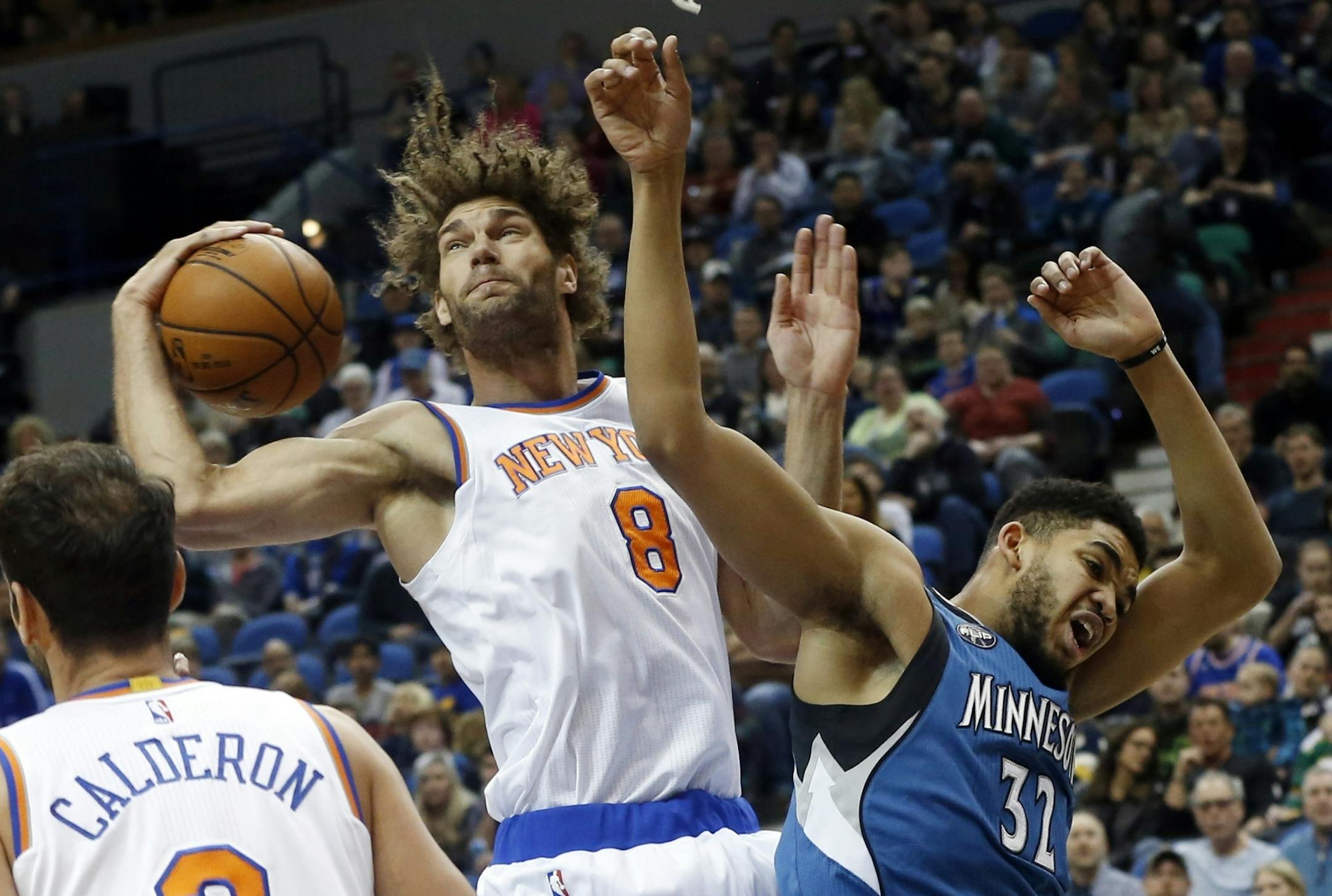 New York Knicks' Robin Lopez, left, beats Minnesota Timberwolves' Karl-Anthony Towns to the rebound during the first quarter of an NBA basketball game Saturday, Feb. 20, 2016, in Minneapolis. (AP Photo/Jim Mone)