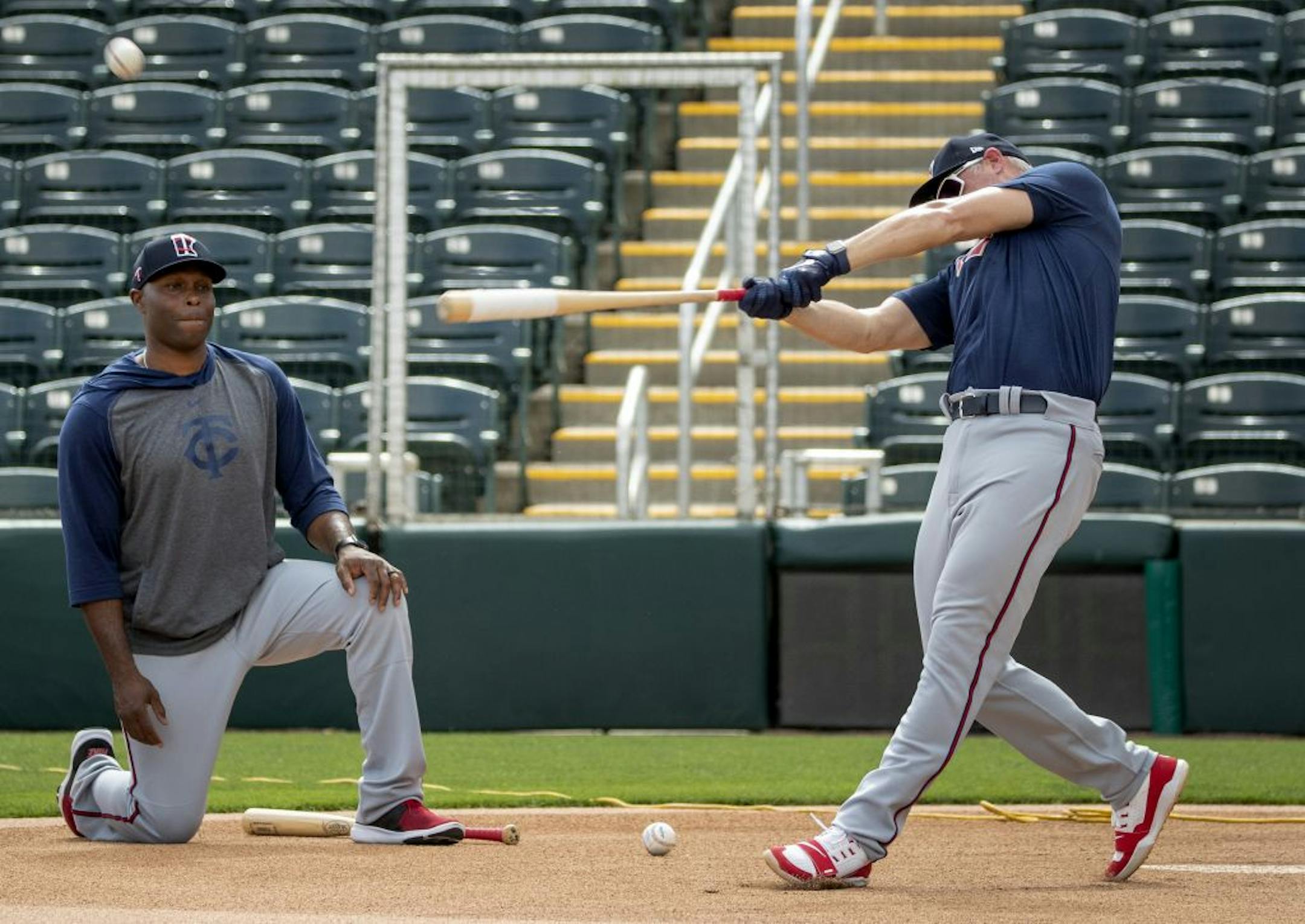 Minnesota Twins special coaches Torii Hunter tossed a ball to Michael Cuddyer as they hit balls to outfielder during practice on Wednesday.