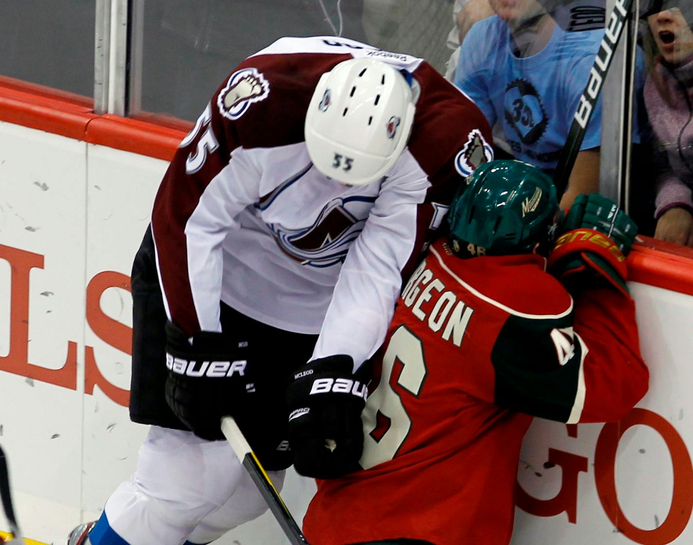 Colorado's Cody McLeod (55) checks the Wild's Jared Spurgeon (46) from behind.