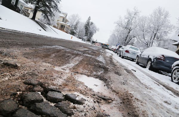 (Note to copy editors: Do not ID this as 4th Street.) Potholes riddle a street in Duluth. Cities thoughout Minnesota are asking the Legislature for mo