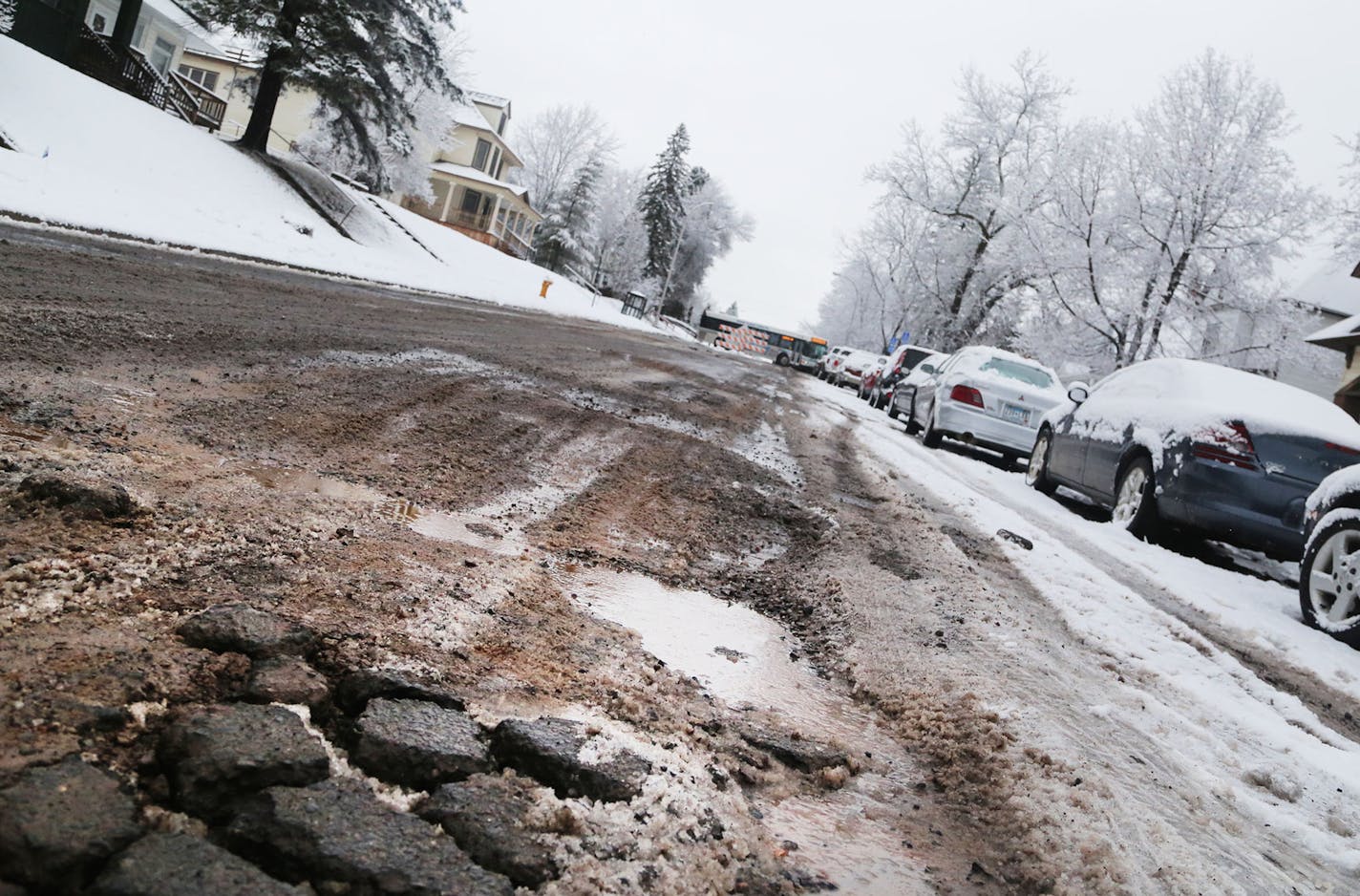 (Note to copy editors: Do not ID this as 4th Street.) Potholes riddle a street in Duluth. Cities thoughout Minnesota are asking the Legislature for money for street maintenance, but perhaps nowhere is the need more dire than in DUluth, an old city buit atop clay and hard rock. Photo by DAVID JOLES