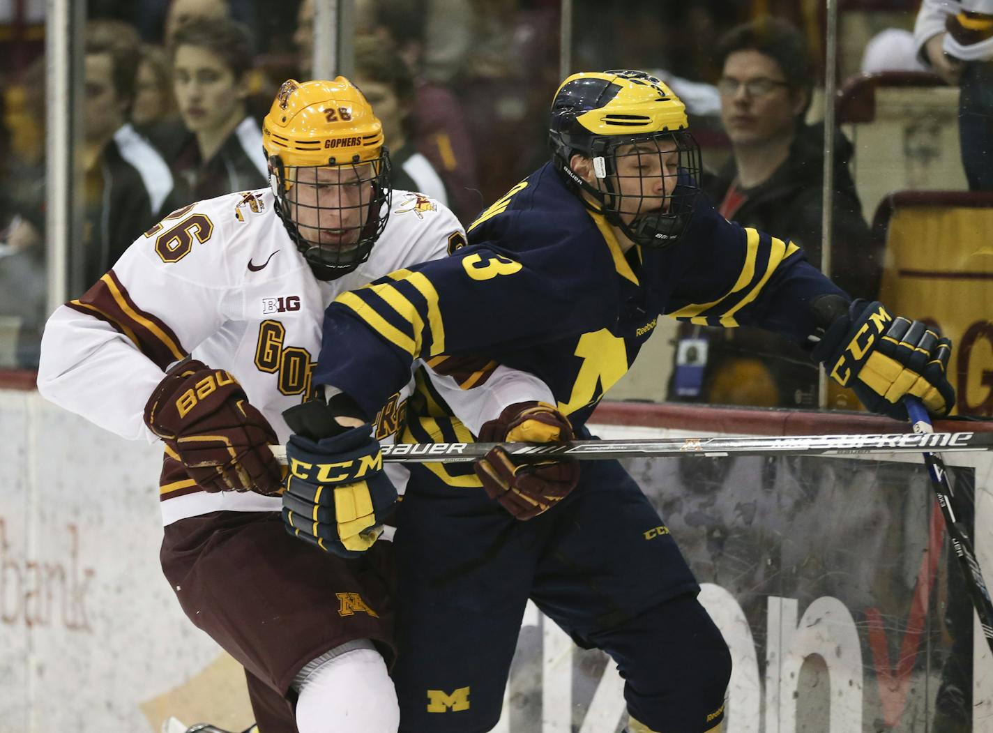 Gophers forward Darian Romanko (26) and Wolverines defenseman Joseph Cecconi (3) tangled as they went for a loose puck in the first period. ] JEFF WHEELER &#xef; jeff.wheeler@startribune.com The University of Minnesota men's hockey team faced the University of Michigan Thursday night, February 25, 2016 at Mariucci Arena in Minneapolis.