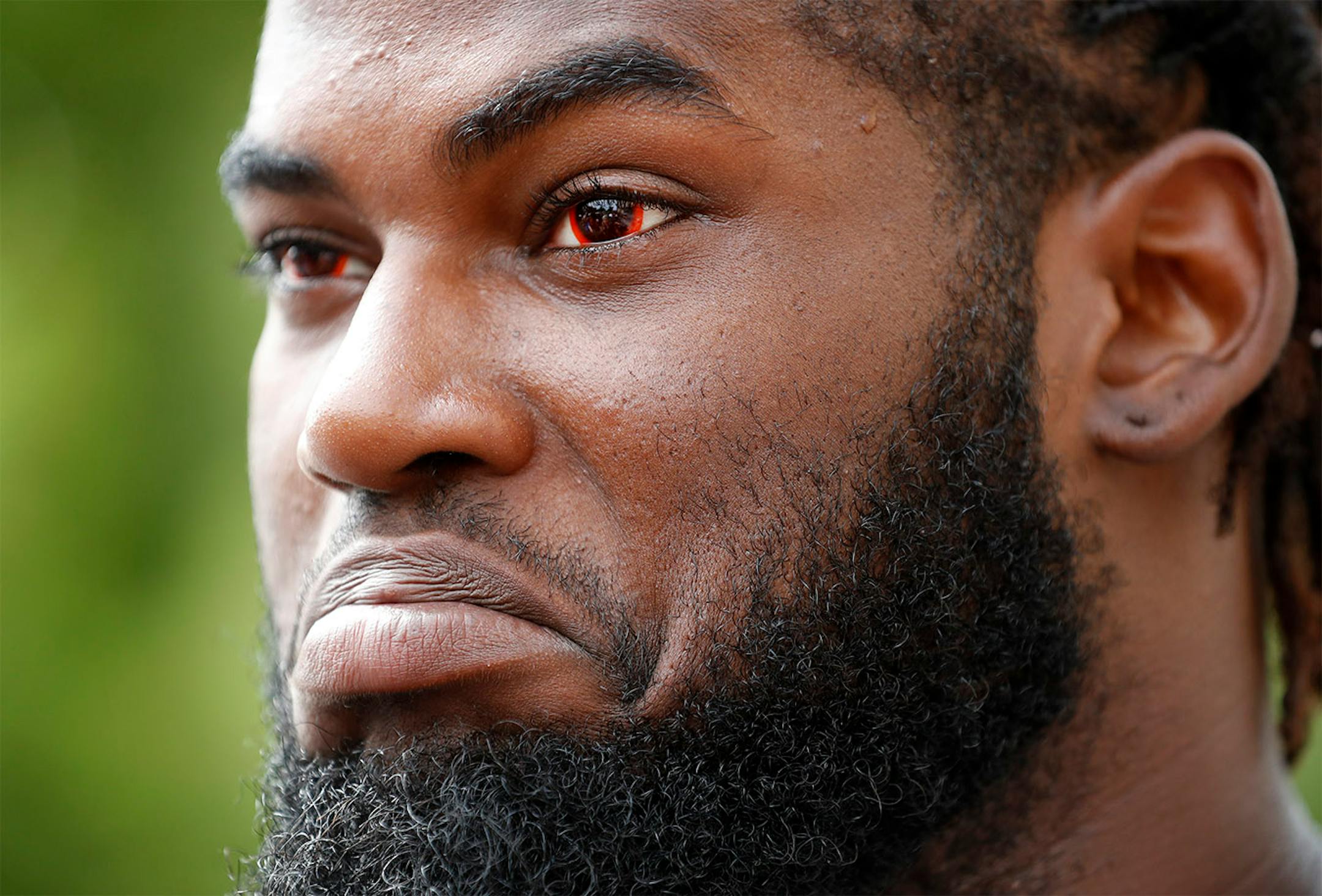 Sharrif Floyd spoke to reporters while wearing red contact lenses.