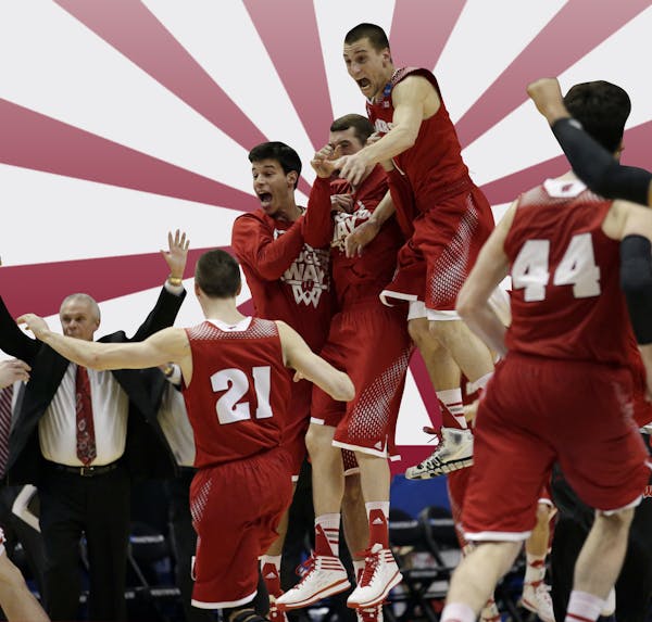 Wisconsin players react as time runs out in overtime in a regional final NCAA college basketball tournament game, Saturday, March 29, 2014, in Anaheim