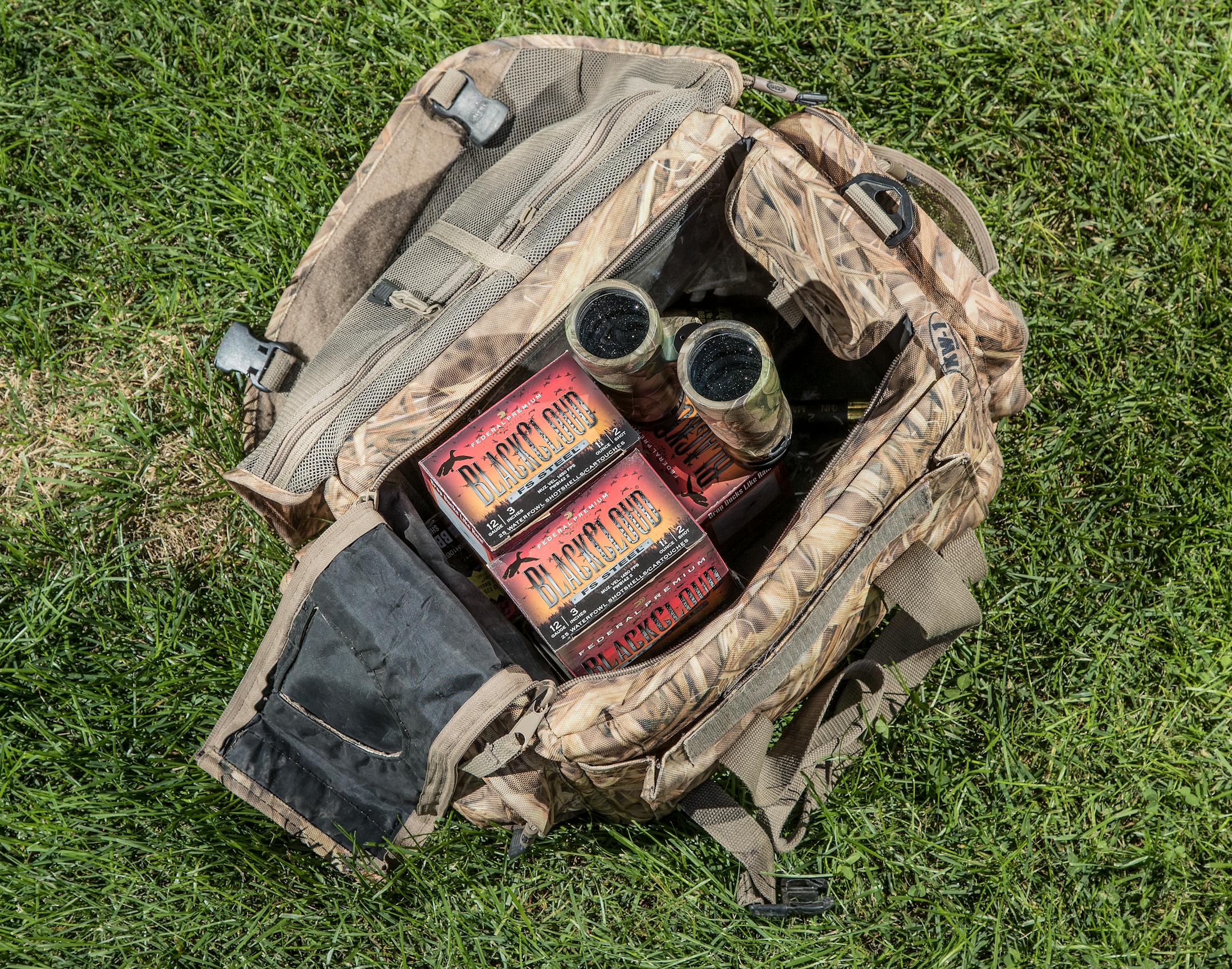 Duck hunting accessories shotgun shells and binoculars. ] CARLOS GONZALEZ cgonzalez@startribune.com - September 14, 2016, Bloomington, MN, duck hunter Jeff Morris in front of or in his old-school duck boat.
