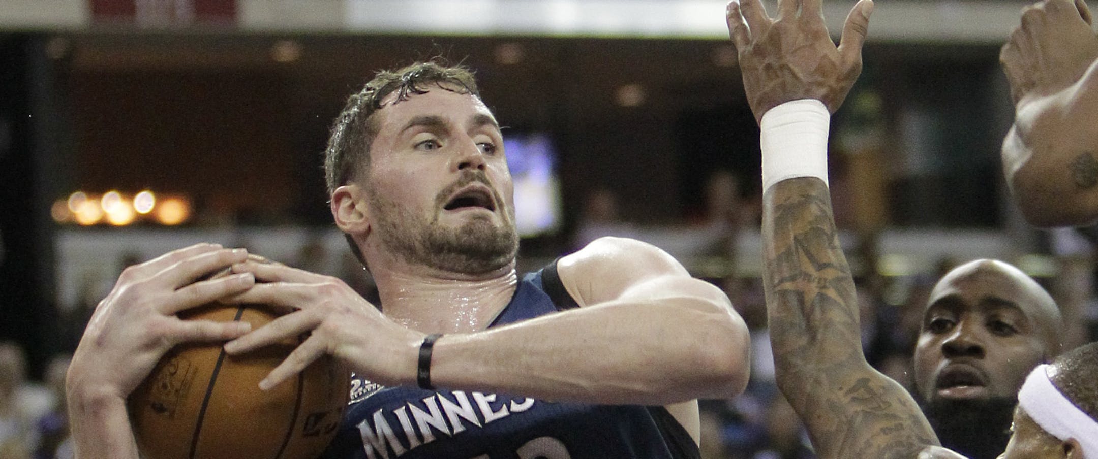Minnesota Timberwolves forward Kevin Love, left, pulls a rebound away from Sacramento Kings' Quincy Acy, center, and Isaiah Thomas during the third quarter of an NBA basketball game in Sacramento, Calif., Saturday, March 1, 2014. The Timberwolves won 108-97.(AP Photo/Rich Pedroncelli)
