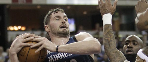 Minnesota Timberwolves forward Kevin Love, left, pulls a rebound away from Sacramento Kings' Quincy Acy, center, and Isaiah Thomas during the third qu