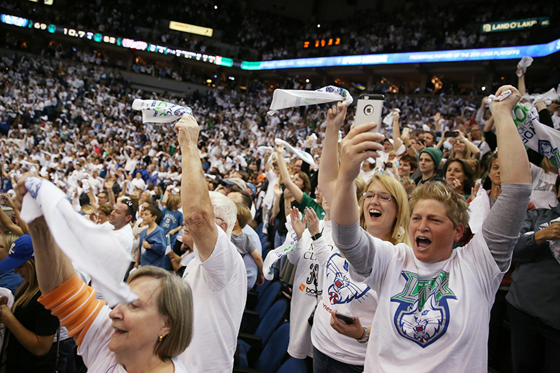 Jeanne Wodarz of White Bear Lake, right, and Kristin Magoris of Minneapolis celebrate the Minnesota Lynx winning the WNBA title.