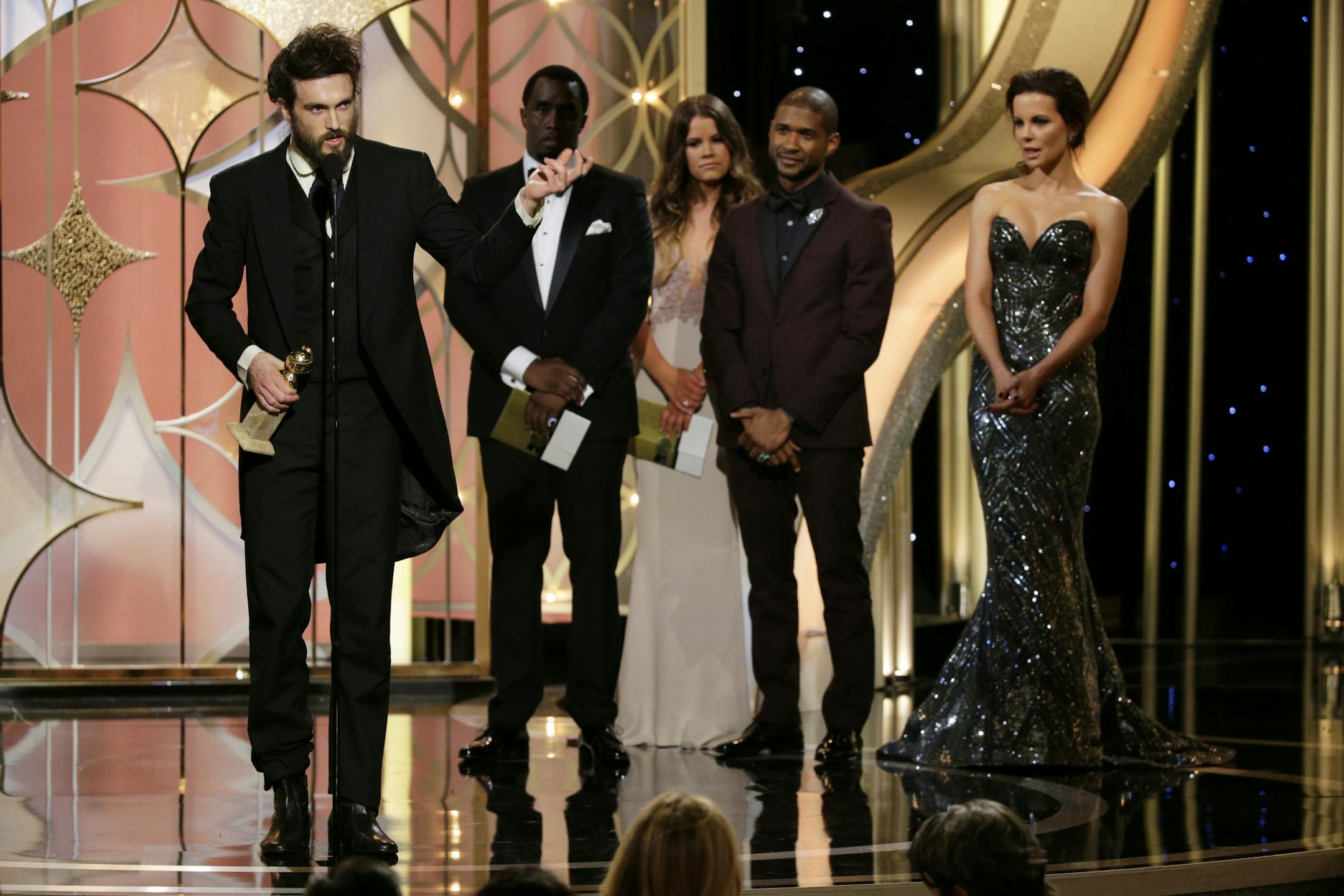 This image released by NBC shows Alex Ebert accepting the award for best original score in a motion picture for "All is Lost," during the 71st annual Golden Globe Awards at the Beverly Hilton Hotel on Sunday, Jan. 12, 2014, in Beverly Hills, Calif.