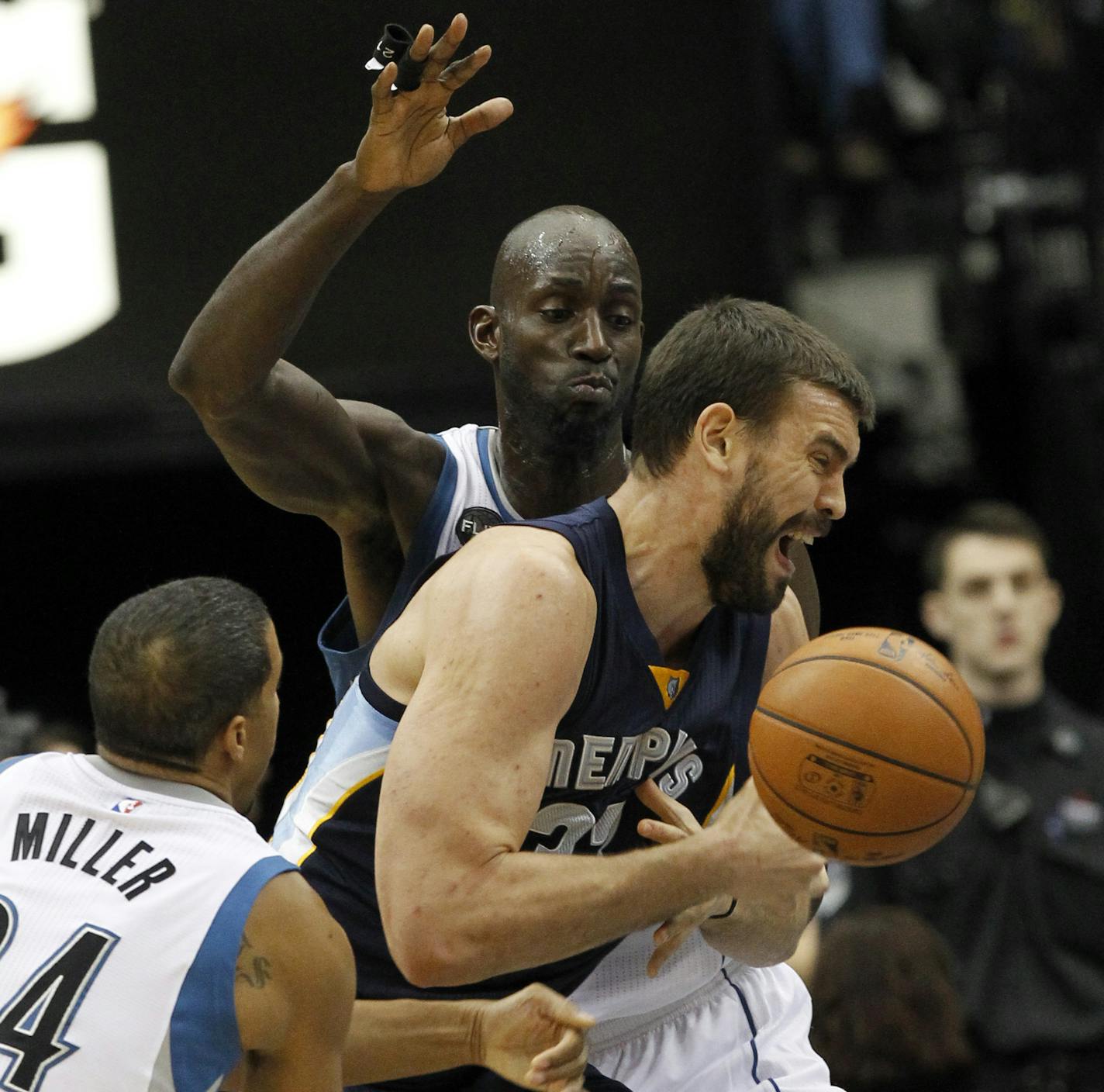 Minnesota Timberwolves guard Andre Miller, left, strips the ball from Memphis Grizzlies center Marc Gasol (33), front right, of Spain, who drives against Timberwolves forward Kevin Garnett, rear, during the first half of an NBA basketball game in Minneapolis, Sunday, Nov. 15, 2015. The Grizzlies won 114-106. (AP Photo/Ann Heisenfelt)