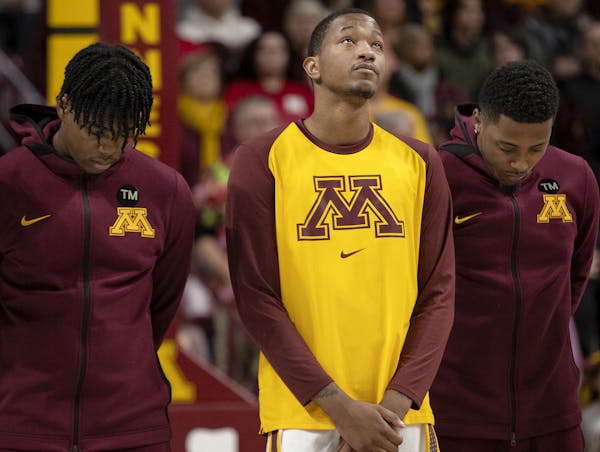 Gophers guard Dupree McBrayer looked up after a moment of silence to honor his mother Tayra McFarlane who passed away earlier this week. ] CARLOS GONZ