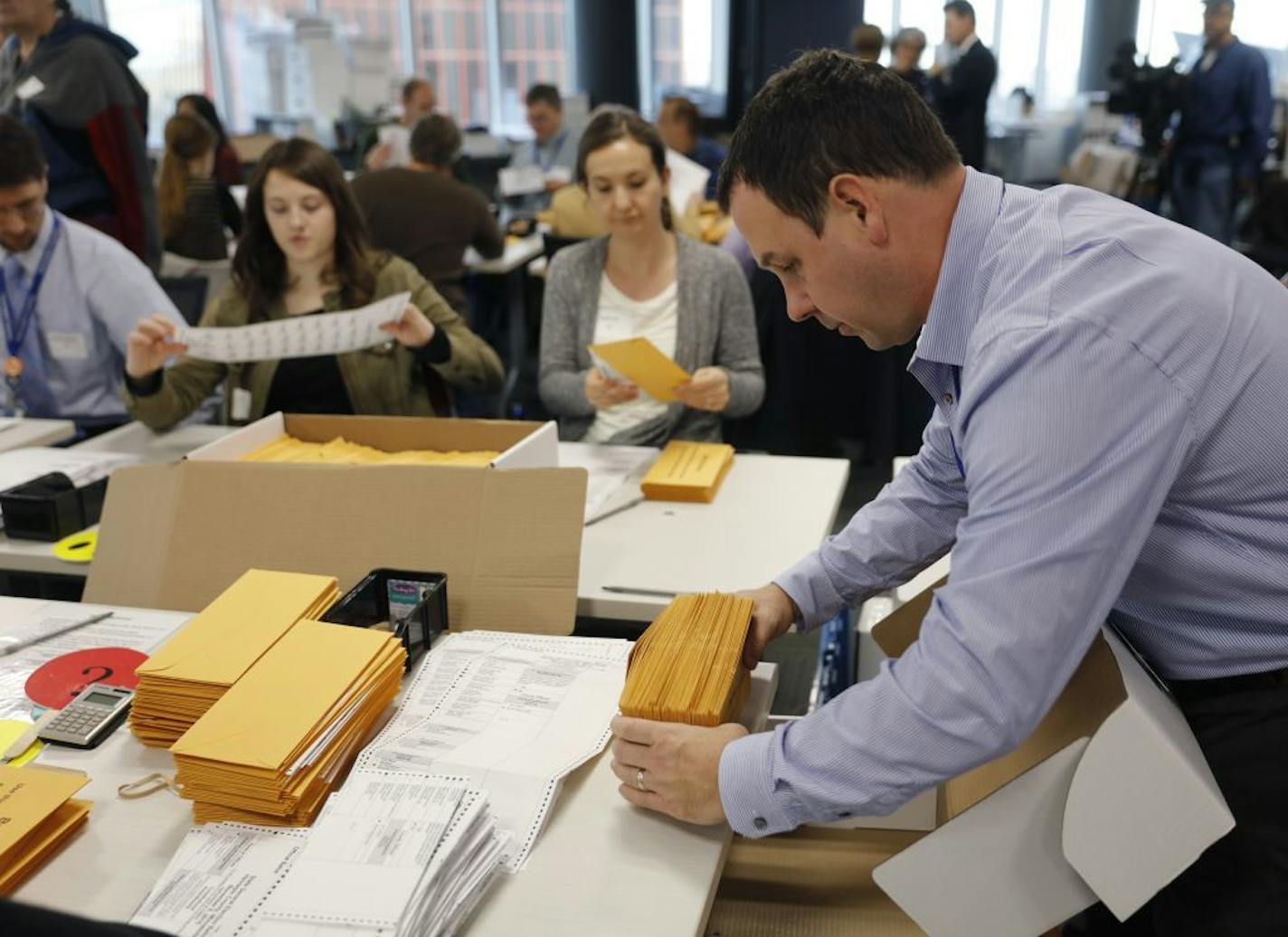 Hundreds of volunteers and election officials started the absentee ballot count this week for all of the Hennepin County cities, except Minneapolis, in downtown Minneapolis. Leif Kurth put empty ballot envelops in a secure box after the ballots were taken out so they could be fed through the counting machines, Nov, 3, 2016