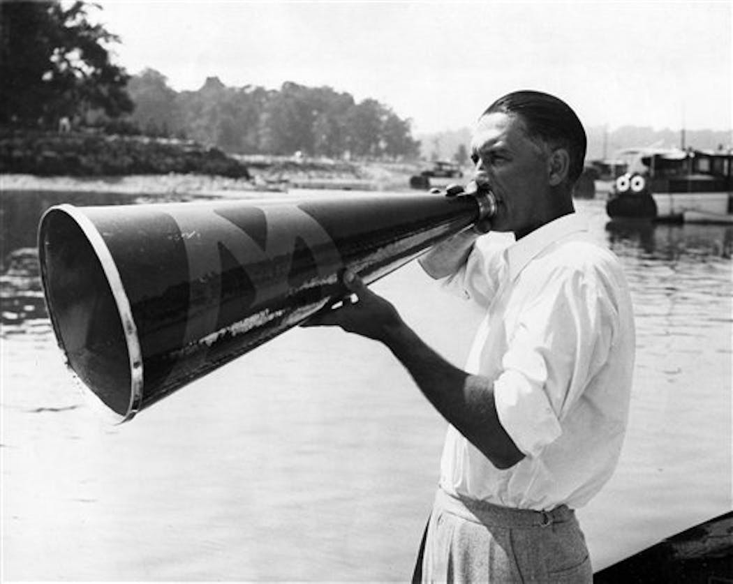 Al Ulbrickson, coach of the University of Washington crew, directed his Huskies in a workout on Long Island Sound, near New York, July 10, 1936.
