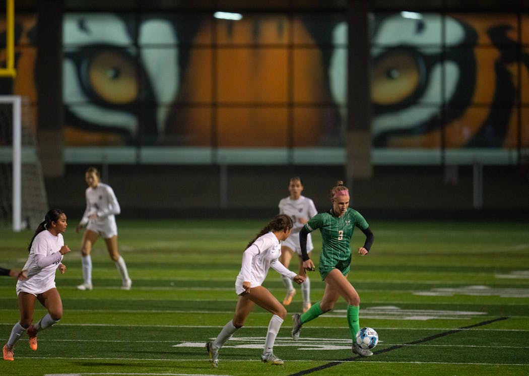 Under the watchful eyes of a defender and a mural, Edina’s Izzy Engle controlled the ball during the state quarterfinal.
