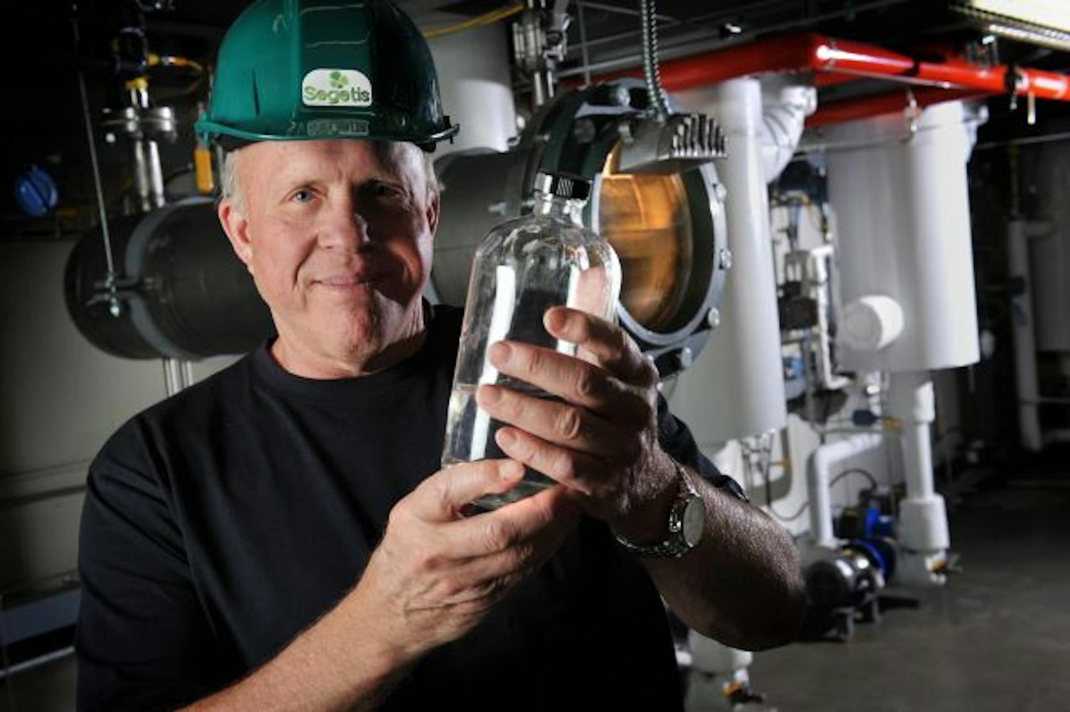 Jim Stoppert, CEO of Segetis, holds a bottle of the company's bio-based chemical building block monomer made out of renewable byproducts from agriculture or forestry industries. The product is intended to replace petroleum-based polymers now used in the production of plastics.