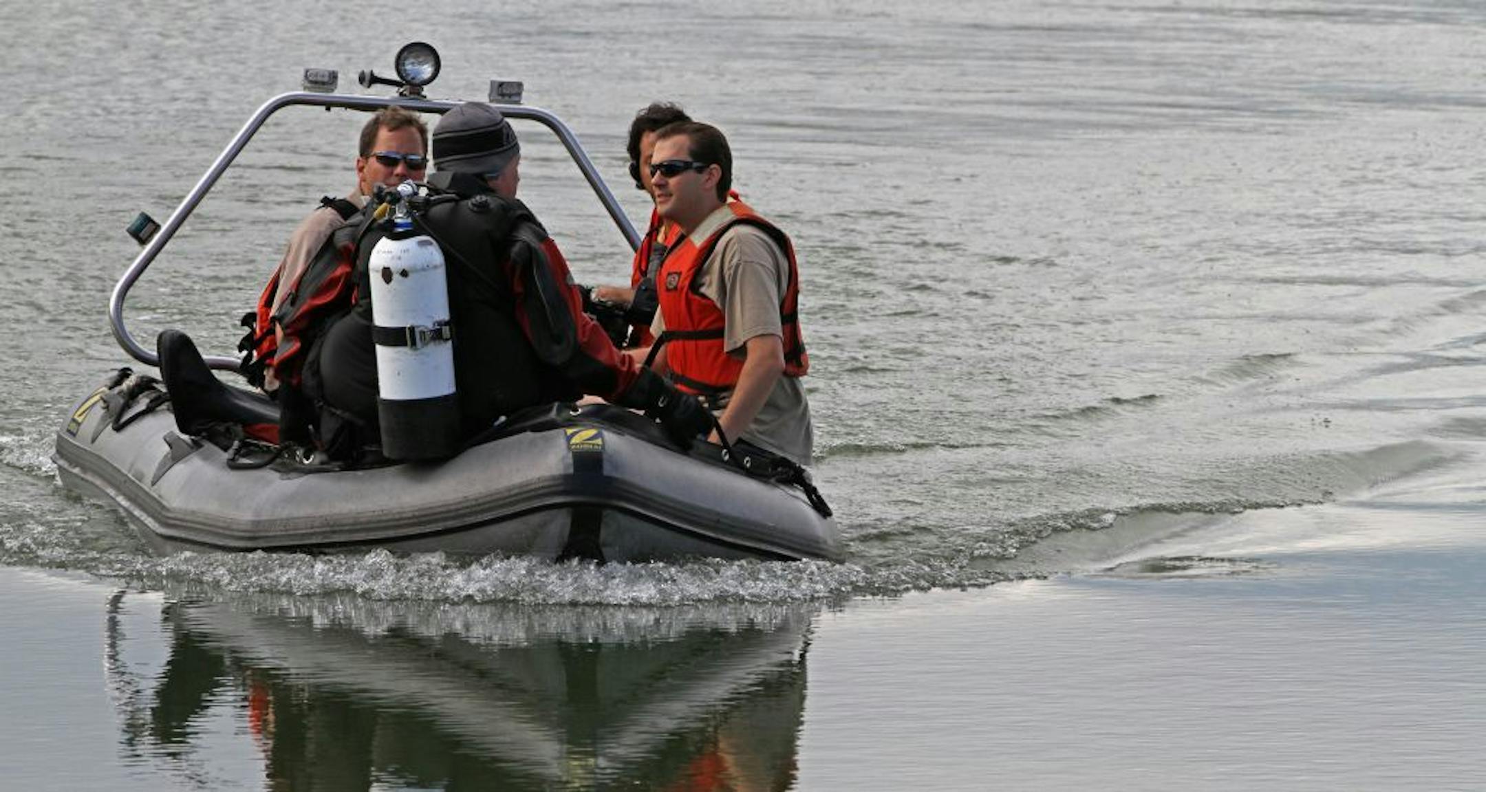 Divers were shuttled back an forth from the dive site in a Zodiac boat, during Hennepin County Sheriff's dive team training exercises at a Maple Grove gravel pit, on 8/20/2011.