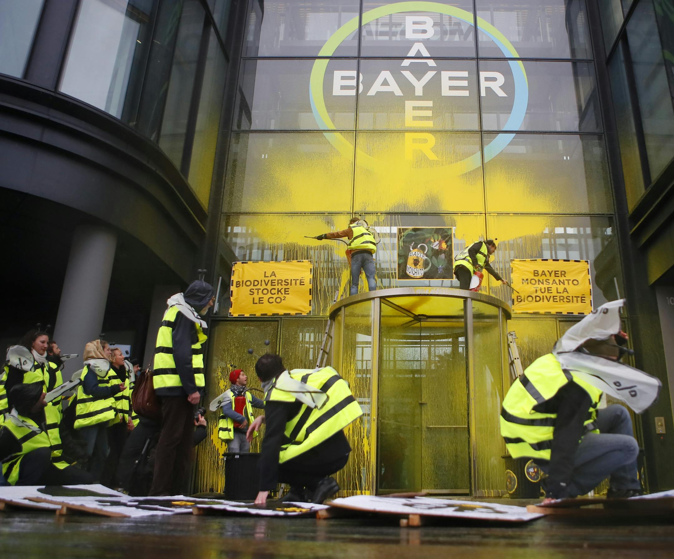 French activists of Attac stage a demonstration in front of the Paris headquarters of Bayer AG to protest its production of environment-damaging pesticides in la Garenne Colombes, suburb of Paris, Thursday, March 14, 2019. Germany-based Bayer is also under fire from environmental activists in Europe and the U.S. for production of weed killer Roundup by its subsidiary Monsanto. Roundup's key ingredient glyphosate has been blamed for health problems including cancer. (AP Photo/Francois Mori) ORG X