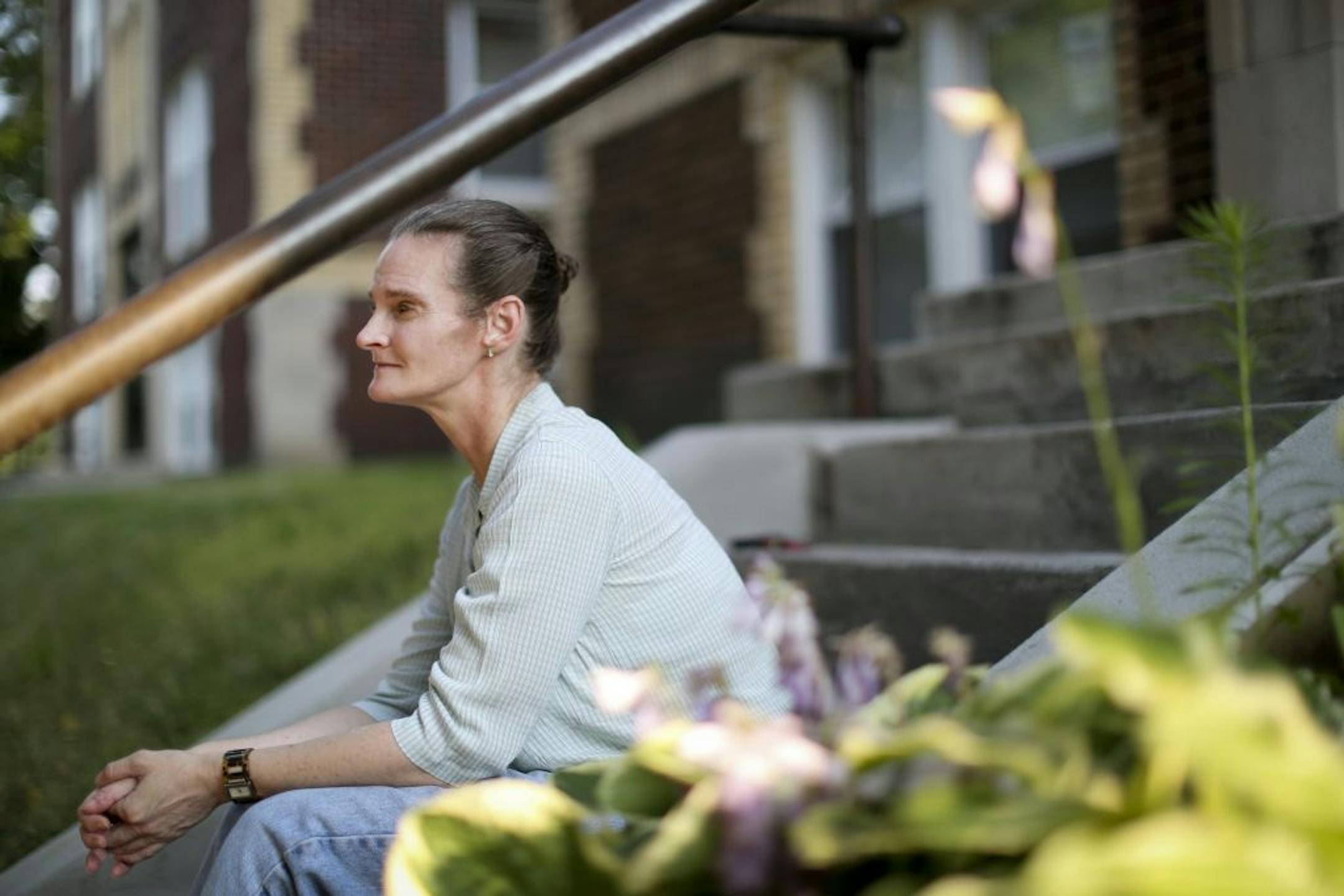 Molly Woolsey, 45, has struggled with anorexia since she was a teenager. She finds it helpful to ground herself when she sits outside on her stoop and breaths slowly. She was pictured at her apartment on July 3, 2012, St. Paul, Minn.