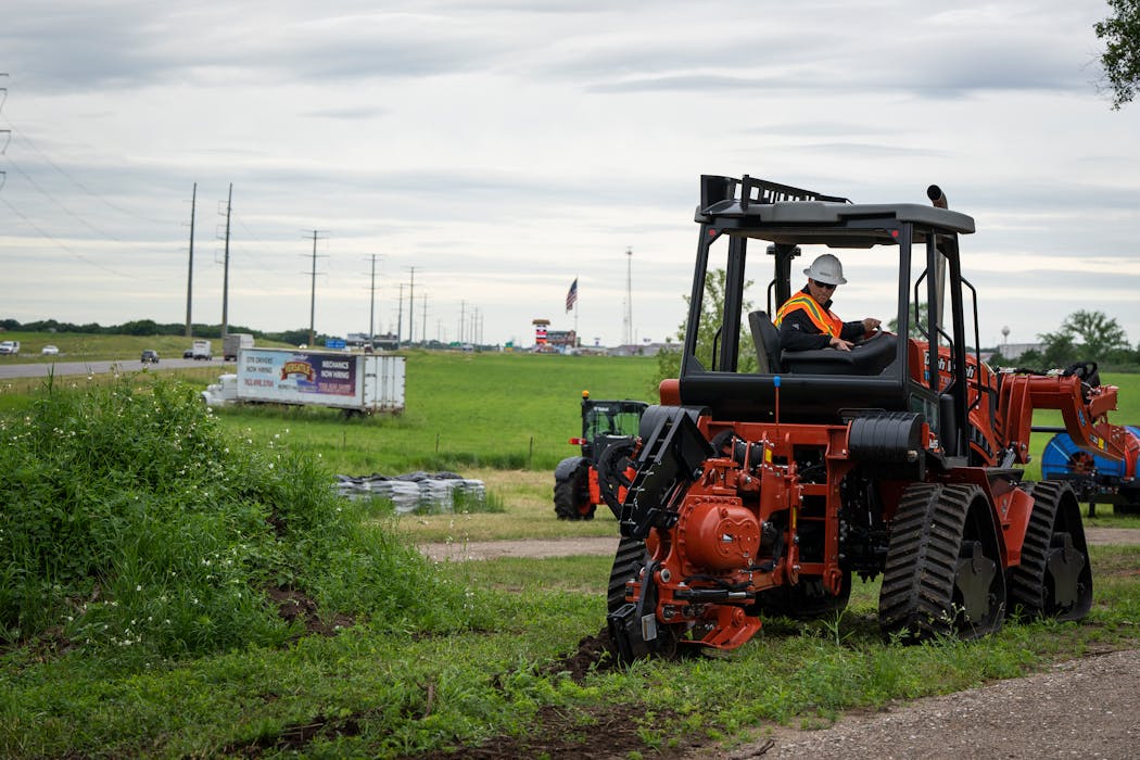 Jerimey Flategraff, an operations manager at TelCom Construction, drives the quad cable plow during a demonstration at a TelCom Construction field training facility in Clearwater, Minn. on Thursday, June 20, 2024. ] LEILA NAVIDI • leila.navidi@startribune.com