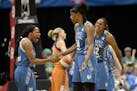 Minnesota Lynx guard Jia Perkins (7) and forward Rebekkah Brunson (32) celebrated with center Sylvia Fowles (34) after Fowles scored a 2-pointer and d