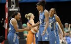 Minnesota Lynx guard Jia Perkins (7) and forward Rebekkah Brunson (32) celebrated with center Sylvia Fowles (34) after Fowles scored a 2-pointer and d