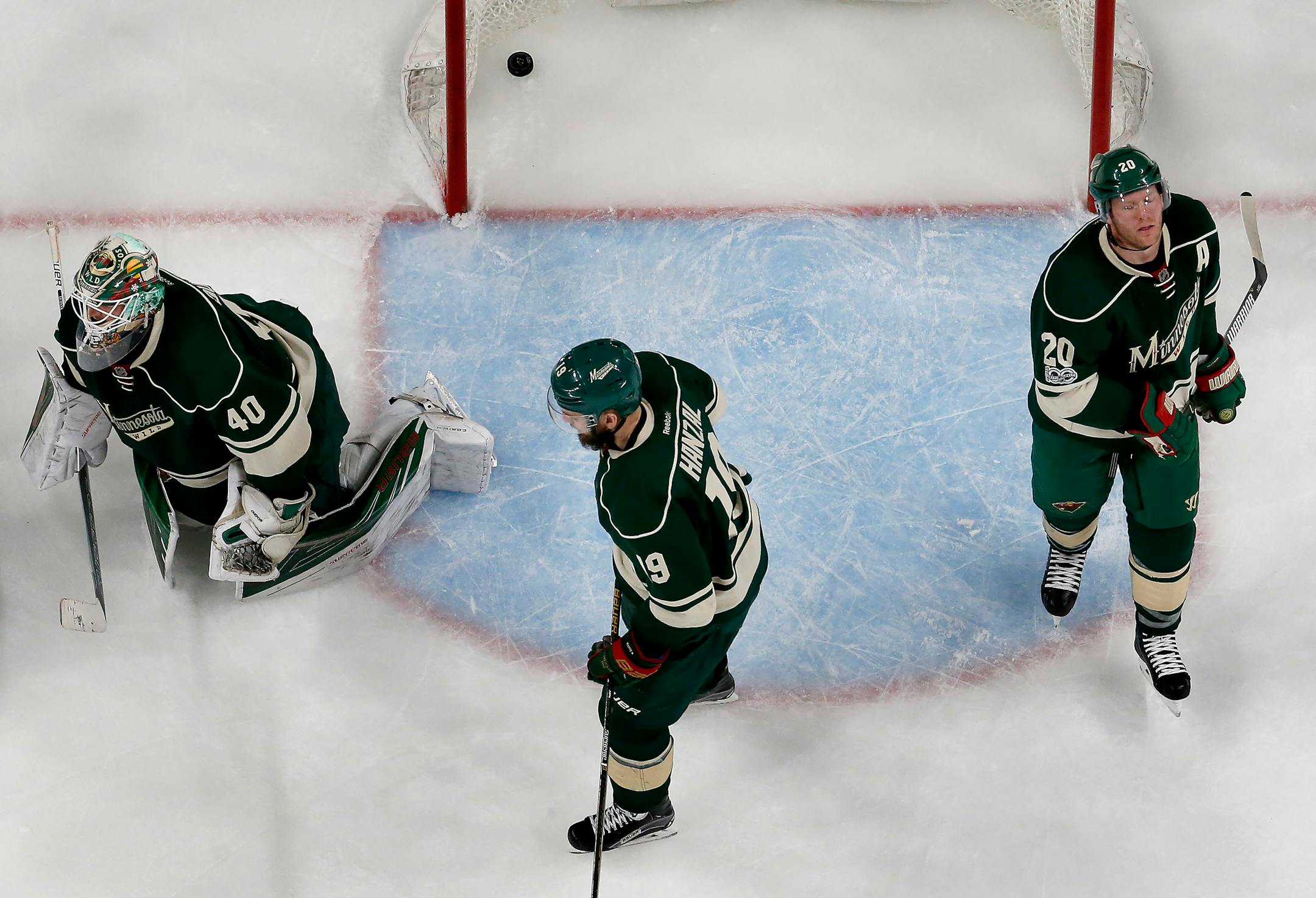 Wild players Devan Dubnyk (40), Martin Hanzal (19) and Ryan Suter (20) -- with the puck from Magnus Paajarvi's series-clinching shot still in the net -- realize their season is over after a 4-3 overtime loss to the St. Louis Blues at Xcel Energy Center on Saturday. ] CARLOS GONZALEZ � cgonzalez@startribune.com - April 22, 2017, St. Paul, MN, Xcel Energy Center, NHL, Stanley Cup Playoffs, Game 5, Minnesota Wild vs. St. Louis Blues